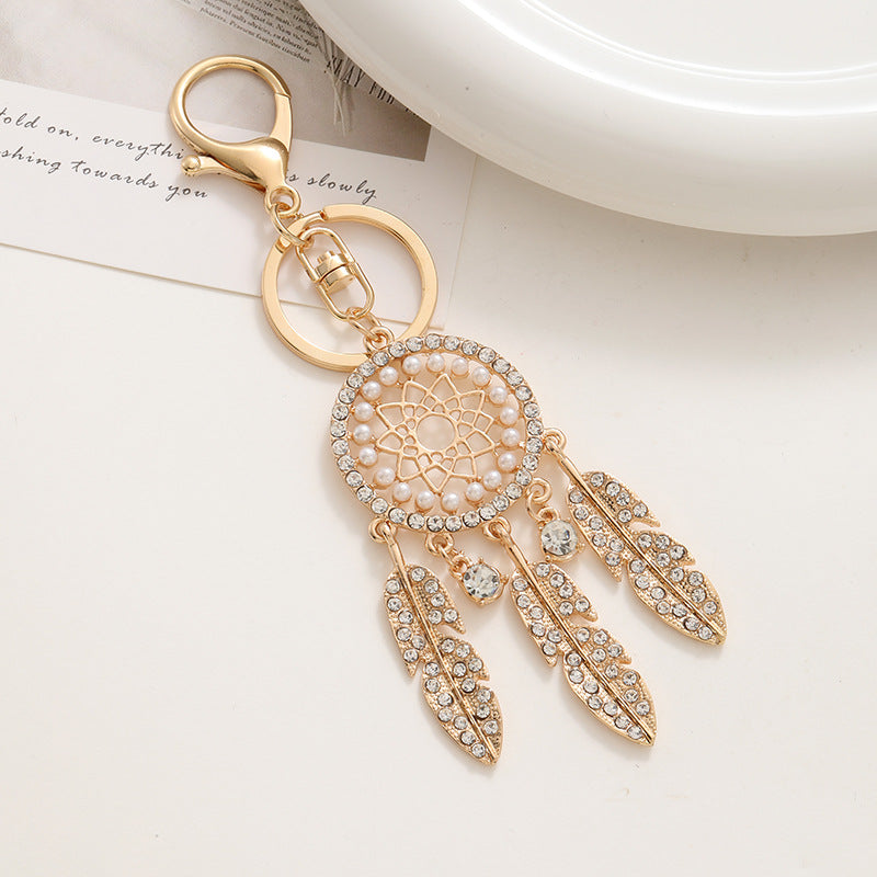 New palace style creative diamond inlaid hollow dream catcher feather keychain car bag pendant metal small gift