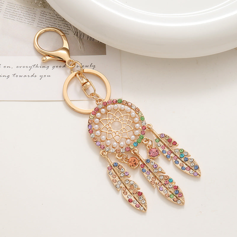 New palace style creative diamond inlaid hollow dream catcher feather keychain car bag pendant metal small gift